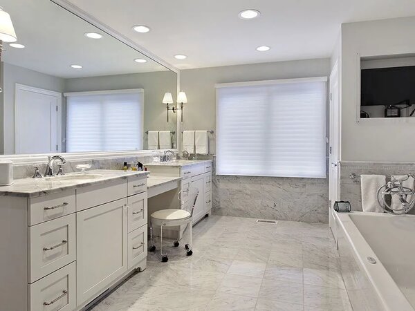 First picture of a modern master bathroom with long vanity and bathtub