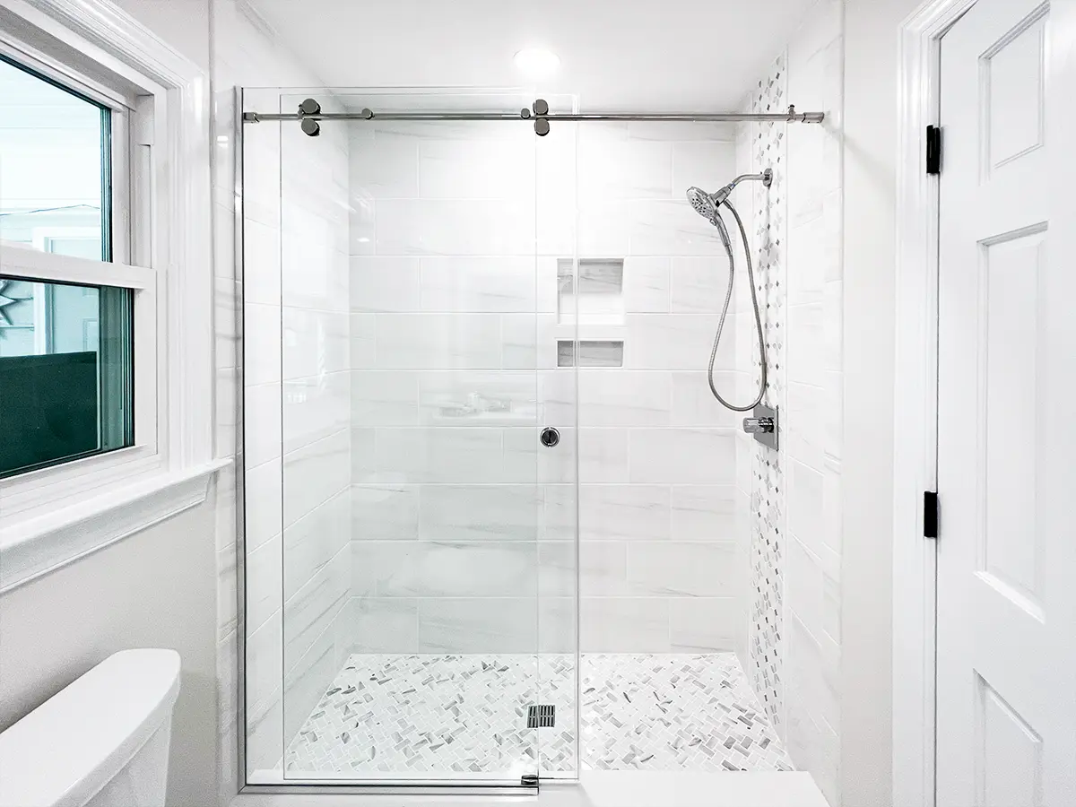 Contemporary bathroom featuring a glass-enclosed shower with tile detailing.