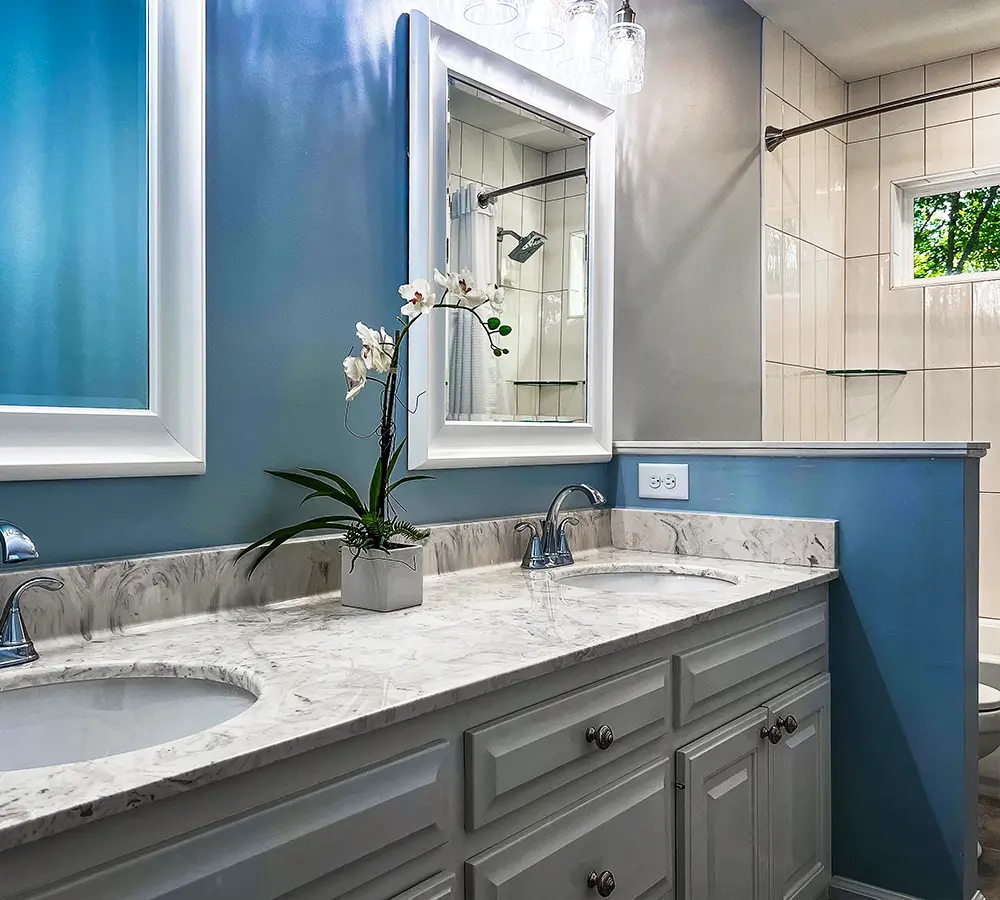 Luxurious bathroom with dual sinks and ample storage cabinets.