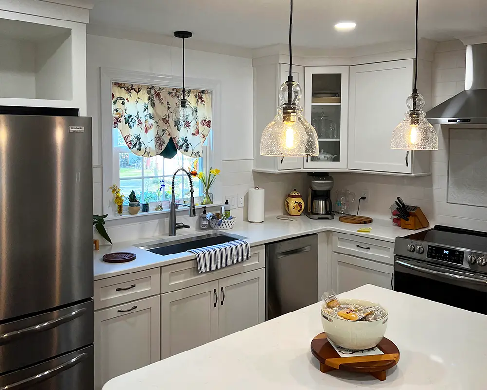 Cozy kitchen design with pendant lighting, stainless steel appliances, and a welcoming atmosphere.