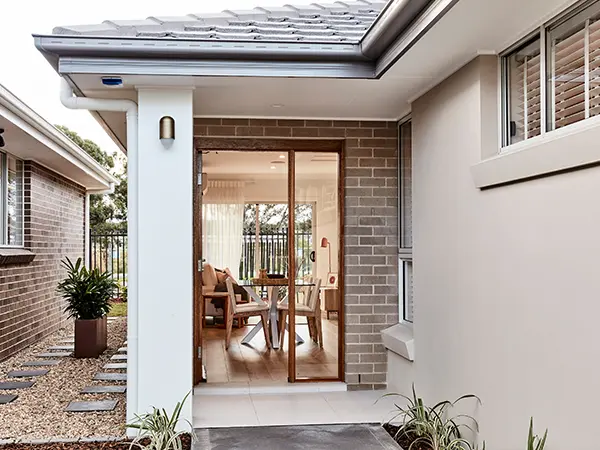 Elegant home exterior showcasing a stylish brick and siding combination with a newly constructed addition.