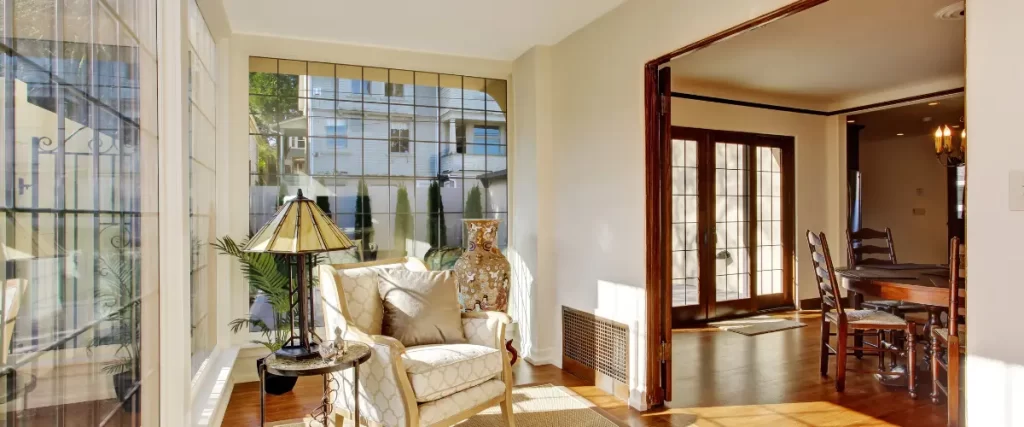 Traditional sunroom with patterned armchairs and natural light