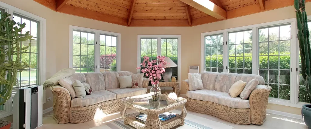 Cozy sunroom with wicker furniture and vaulted wood ceiling