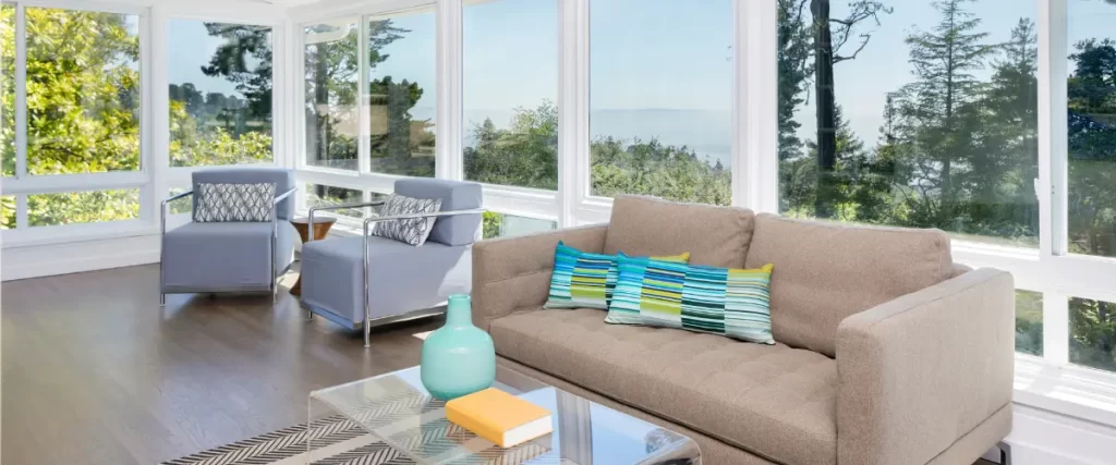 Contemporary sunroom featuring panoramic windows and stylish seating