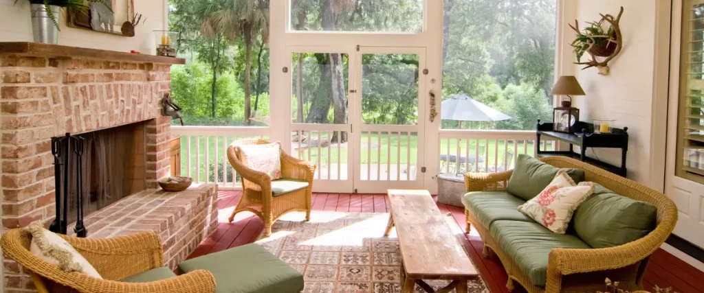 Cozy sunroom with natural light, wooden furniture, and garden view