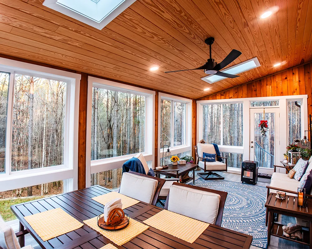 Sunroom addition with furniture and large windows